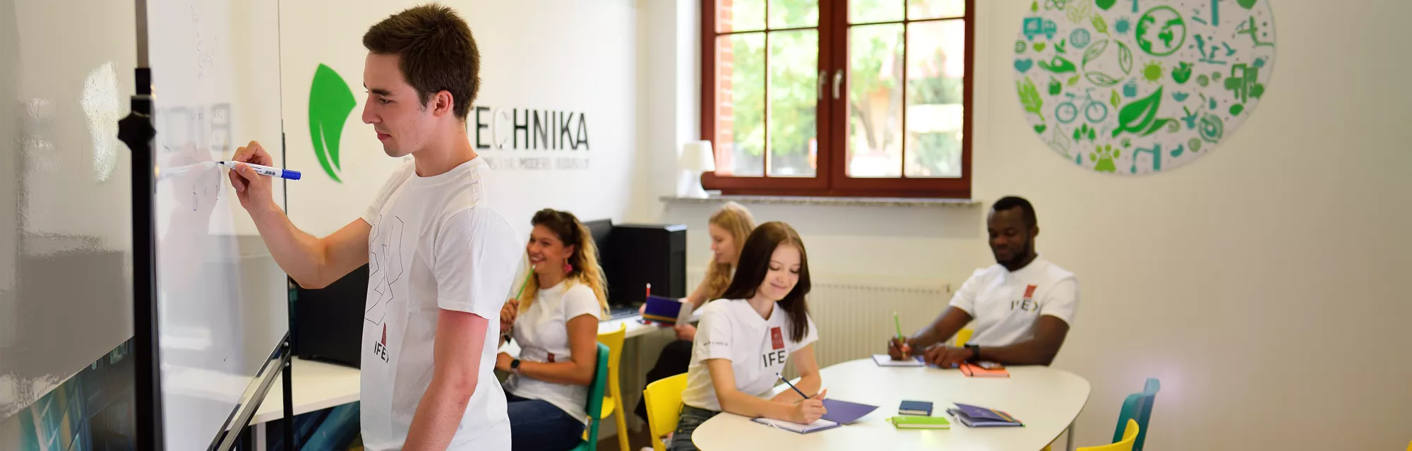 A student writes on the board in the classroom.