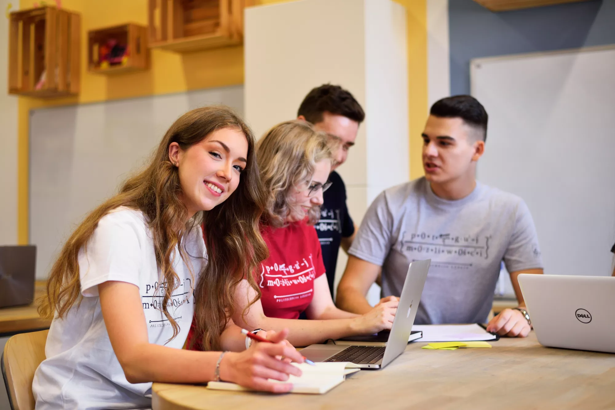 Students sitting at a table and talking. 