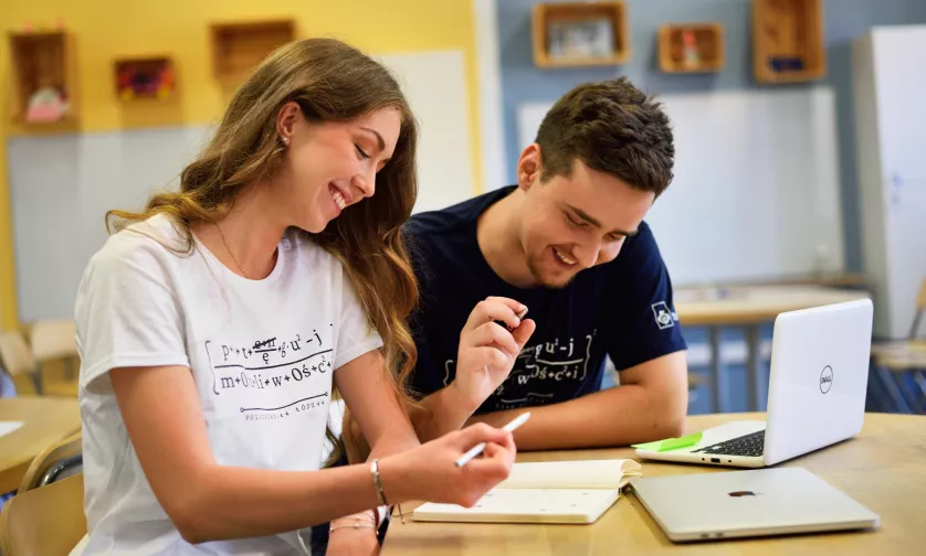 Two students solve the task in one notebook.