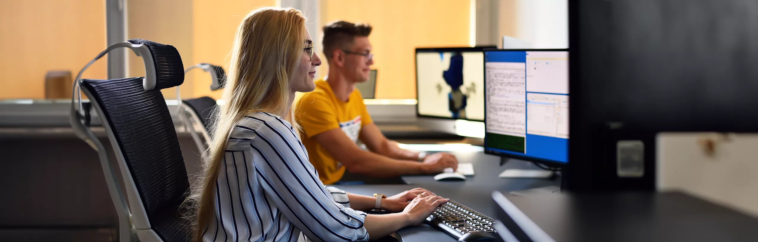 Students working on computers in a classroom. 